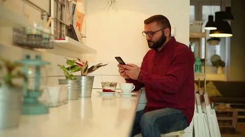 Man browsing internet on smartphone in the restaurant Video stock 70858933