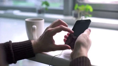 Man browsing internet on smartphone sitting at cafe Stock Footage 75774782