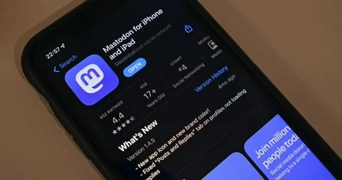Man browsing Mastodon app introduction page in App Store on an iPhone Stock Footage 221010471