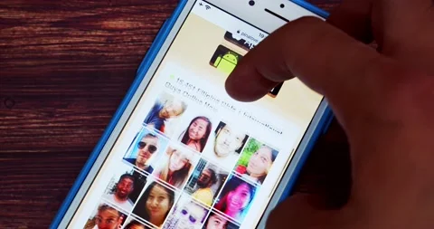 Man browsing PinaLove website on iPhone on wooden table Stock Footage 207548665