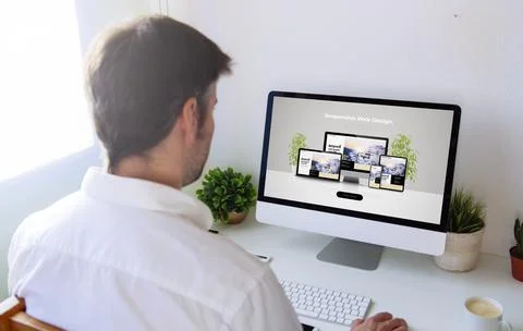 Man browsing responsive devices website on computer Stock Photos