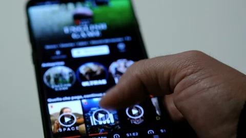 Man browsing on a smartphone netflix app series catalog,video streaming platform Video stock 126831328