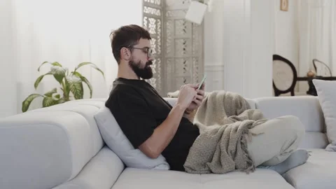 Man browsing smartphone in room Stock Footage 259837740