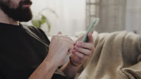 Man browsing smartphone in room Stock Footage 265404177