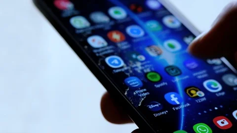 Man browsing on a smartphone,tap on google meet app,video call,covid quarantine Stock Footage 129867502