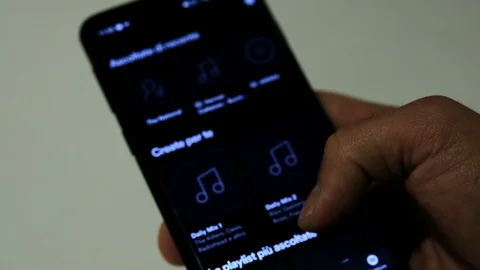 Man browsing Spotify App genre catalog On A Smartphone,streaming music platform Stock Footage 126858809