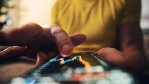 Man Browsing Stock Price Chart In Investment App On Smartphone Screen Stock Photos