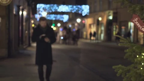Man browsing tablet, walks up, goes away, night, Christmas, steadicam 库存影片 72782222