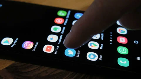 Man browsing on Twitter smartphone app to check new tweets,social network Stock Footage 131316471