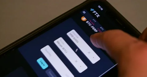 Man browsing the website of FTX (FTX Cryptocurrency Exchange) on iPhone screen Stock Footage 221123693