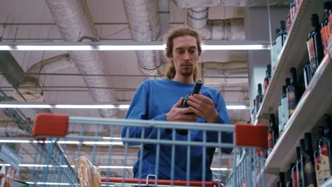 Man Browsing Wine Selection in Alcohol Department Stock Footage 330953136