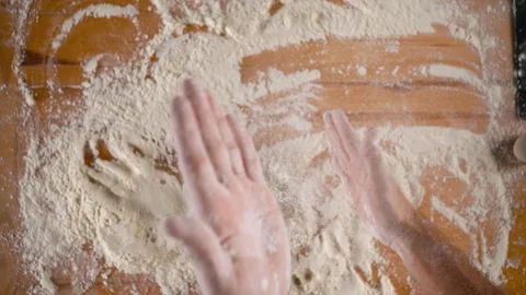 Man brushes off hands from the flour. Video stock 253103800