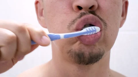 The man brushes his teeth with toothbrush with toothpaste close-up. Stock Footage 308509041