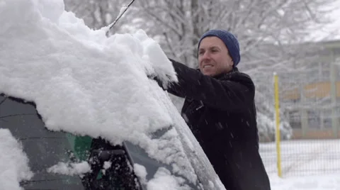 Man Brushes Snow Off The Back Windshield Of The Car Stock Footage 45391362