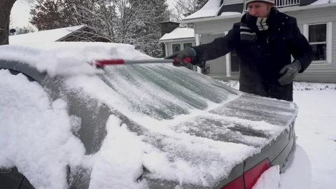 Man Brushes Snow off rear of a Grey Car Stock Footage 147630829