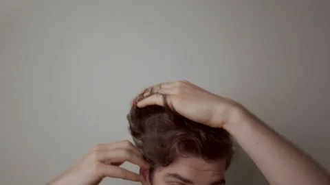 Man brushing his hair, forehead and scal... | Stock Video | Pond5