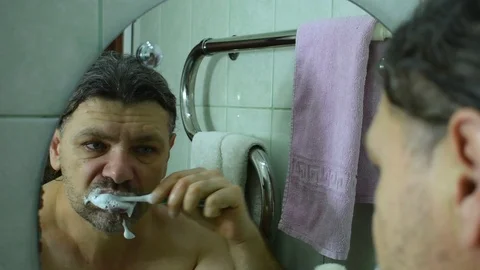 Man brushing his teeth Stock Footage 122123915