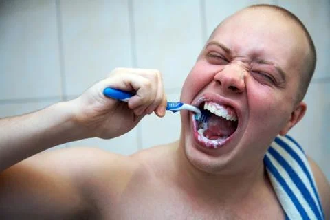 Man brushing his teeth Stock Photos