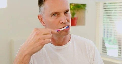 Man brushing his teeth with toothbrush 4k Stock Footage