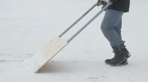 Man brushing snow shovel  in the courtyard Stock Footage 59665574