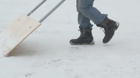 Man brushing snow shovel  in the courtyard, panoramic Video stock 59665707