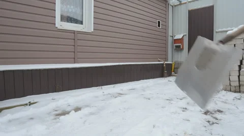 Man Brushing Snow Shovel  Stock Footage 59025152