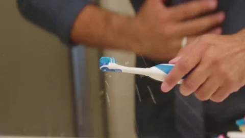 Man brushing teeth in the bathroom Stock-Footage 83188823