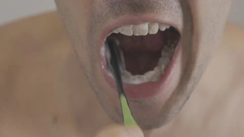 Man brushing teeth in bathroom Stock Footage 86526321
