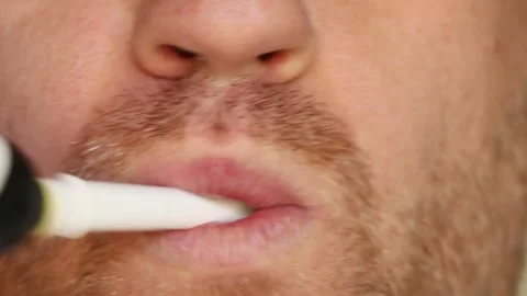 Man brushing teeth close-up: open mouth with toothbrush and foam, oral care Stock Footage 313432443