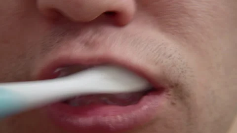 Man brushing teeth with toothbrush for oral hygiene Stock Footage 340609288