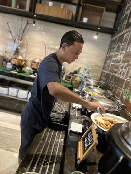 A man in the buffet counter Stock Photos