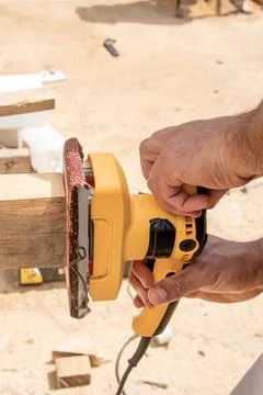 Man Builder Carpenter Sanding Surface Wooden Board Beam With Grinder machine Photos