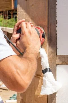 Man Builder Carpenter Sanding Surface Wooden Board Beam With Orbital Sander.. Photos