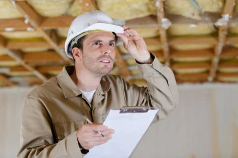 Man builder checking the state of the construction Stock Photos