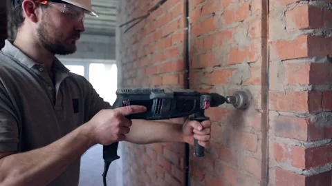 A man builder at a construction site works as a performer. Stock Footage 156307959