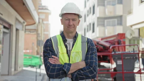Man builder in hardhat and safety vest giving thumbs up on urban street con.. Stock Footage 339177771