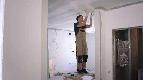 Man builder makes markings on plaster fretwork with pencil Stock Footage 152850203