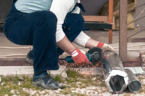 A man builder makes repairs around the house. Hammer, sparks. Stock Photos