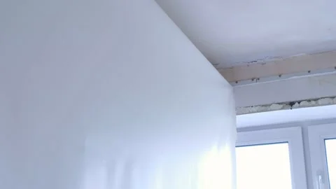 Man builder making demontage of stretch suspended ceiling cuts it using knife. Stock Footage 137498120