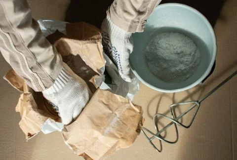 Man builder prepares a mixture for putty Stock Photos