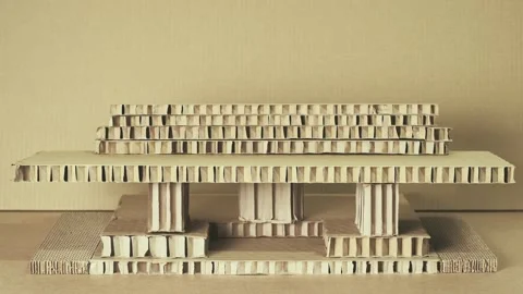 Man Building Architectural Model from Layered Honeycomb Cardboard Panels Stock Footage 330917820
