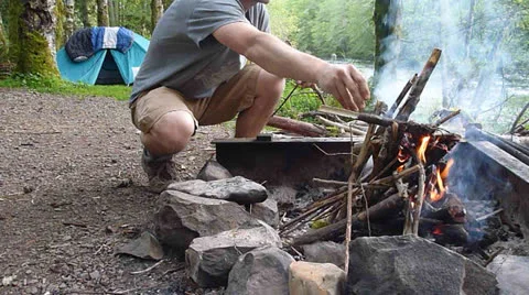 Man Building Campfire Stock Footage 22917209