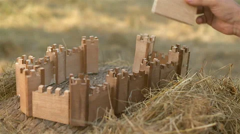 A man building a castle model Stock Footage 62473267