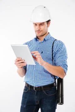 Man building engineer in hard hat standing and using tablet Stock Photos