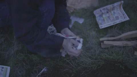 Man Building Fire In Nature | Stock Video | Pond5