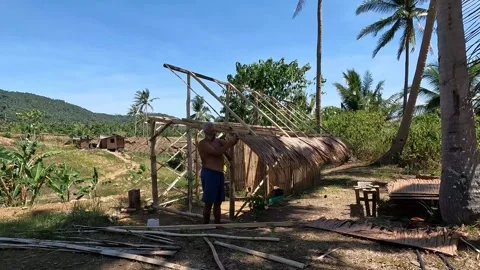 Man building a native hut Stock Footage 277673155