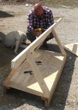 Man Building Small Structure Stock Photos