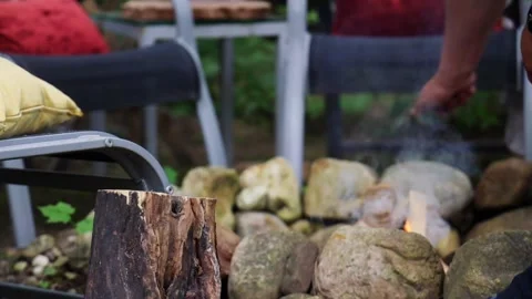 A man builds a fire in the summer Stock Footage 277568851