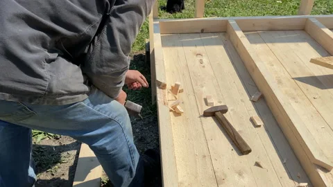 A man builds the frame of a gazebo. Stock Footage 154204402