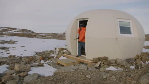Man builds igloo in Antarctica during winter for shelter and research activities Stock Footage 288193645